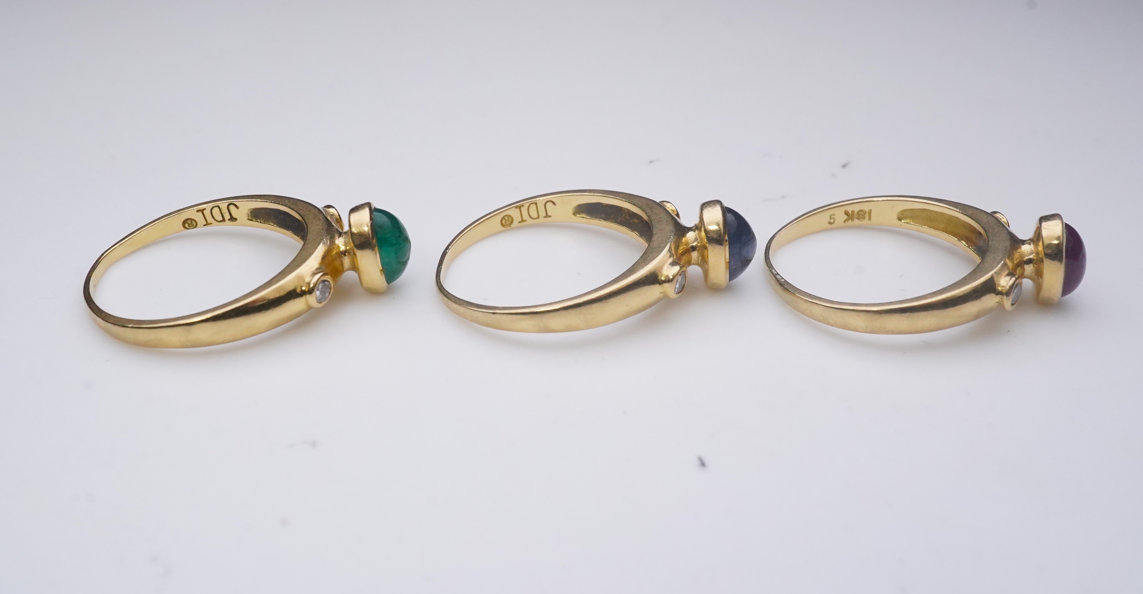 A suite of three gold and gem-set rings